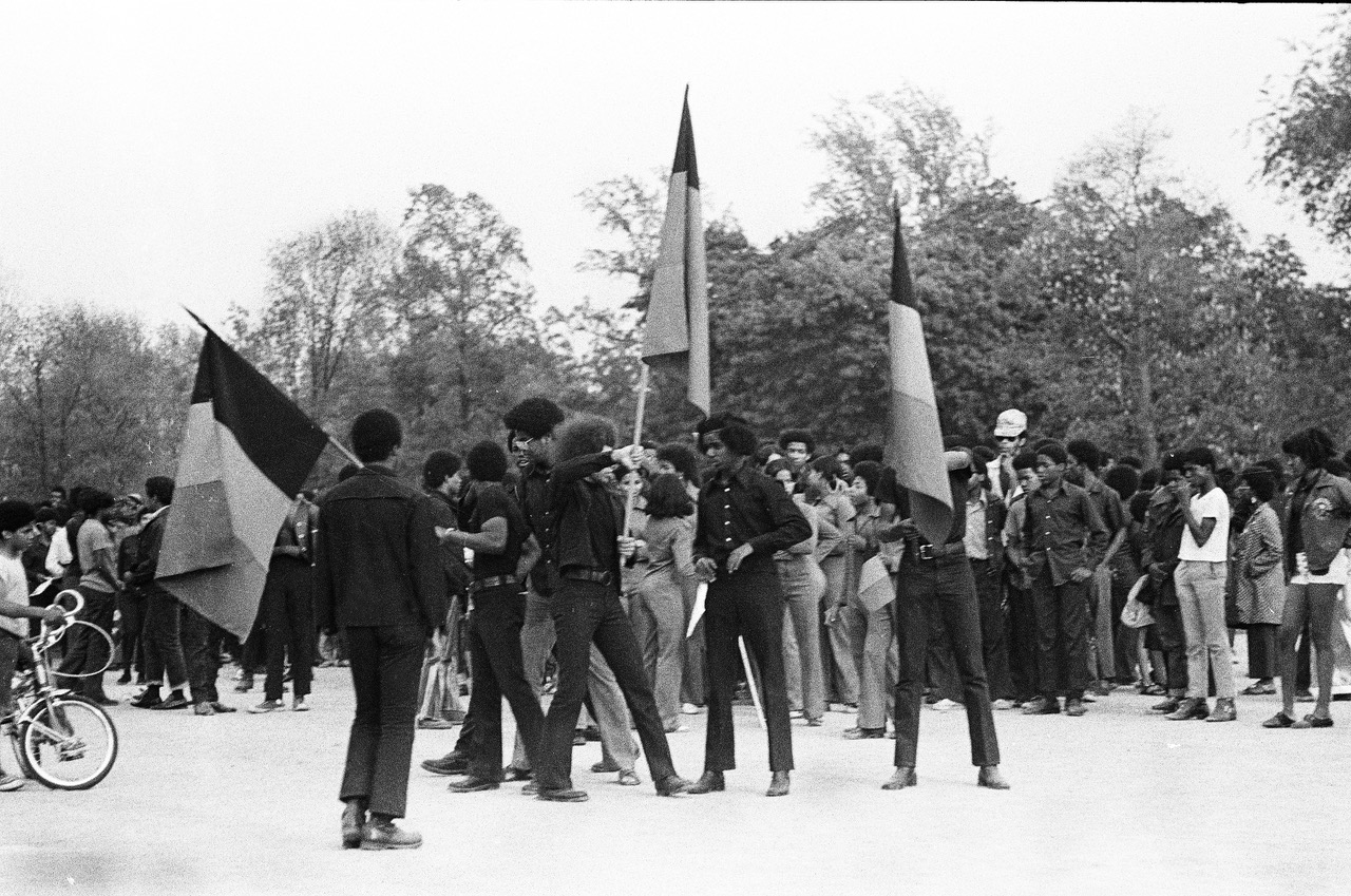 Black students stand with flags